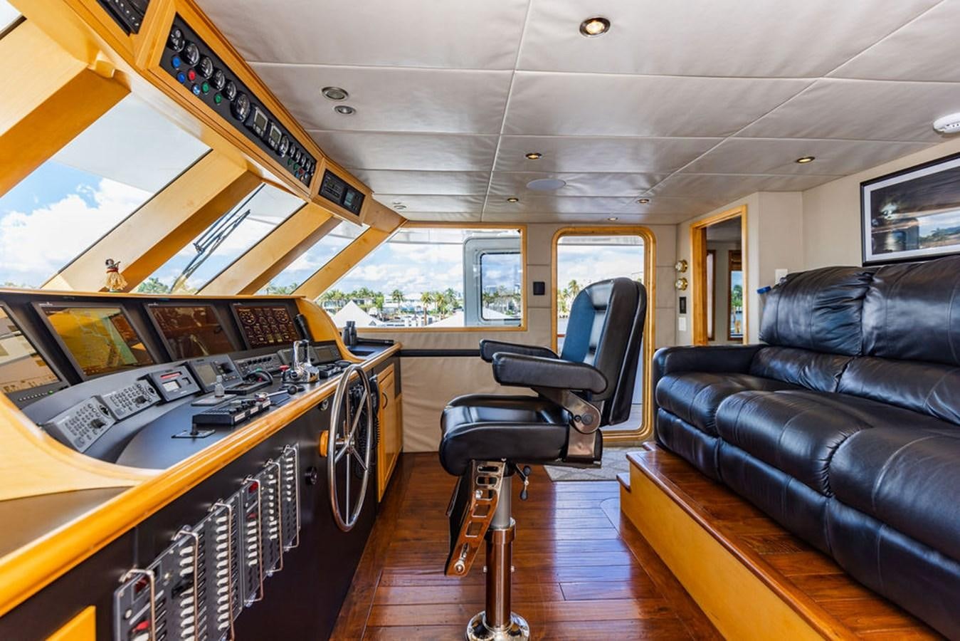 a large room with a couch and a piano aboard EMPIRE SEA Yacht for Sale