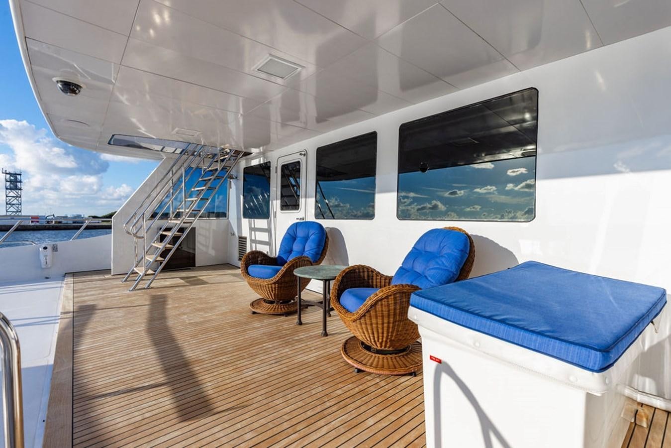 a large white tent with a blue couch and a wood floor aboard EMPIRE SEA Yacht for Sale