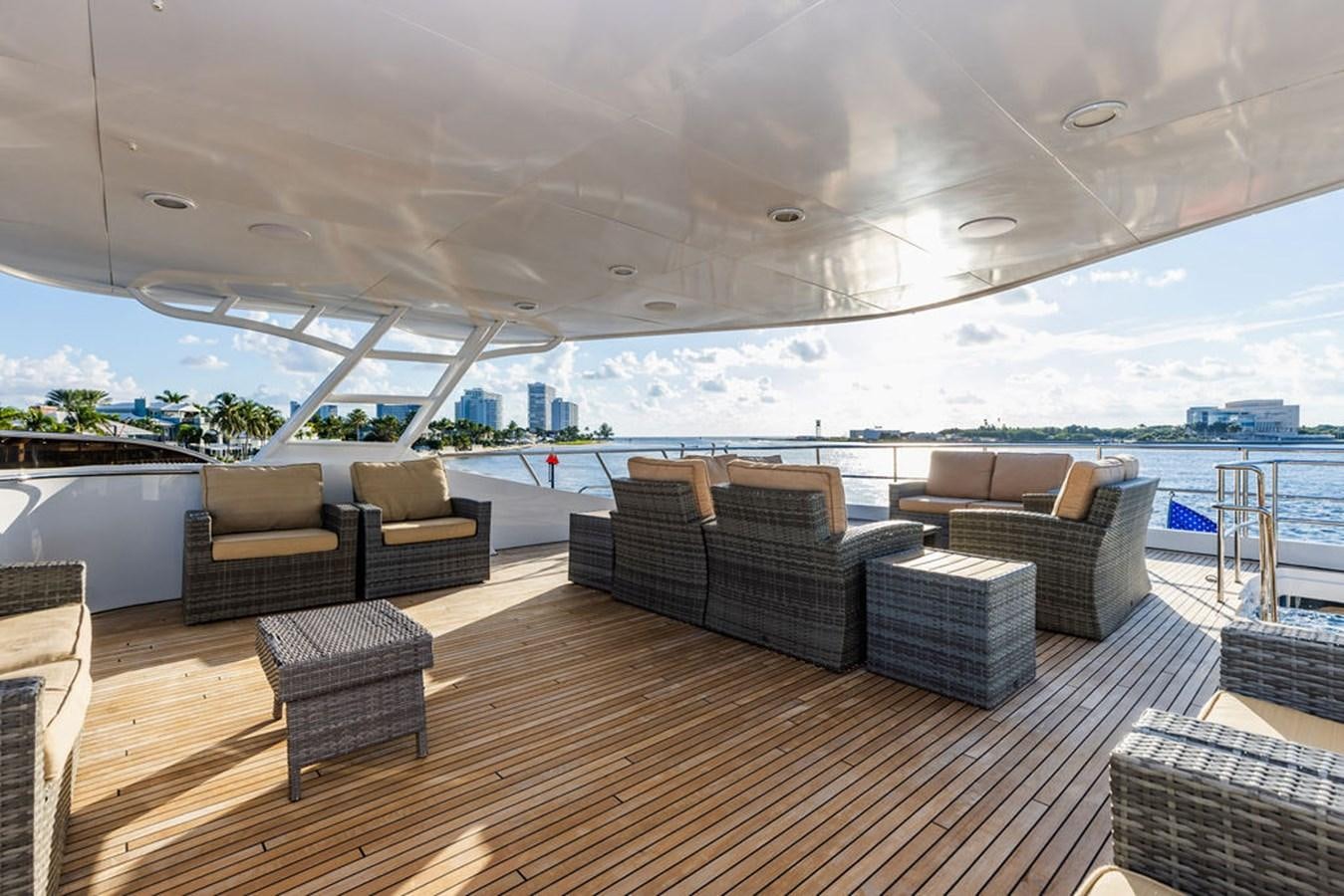a large living room with a large deck and a large pool aboard EMPIRE SEA Yacht for Sale