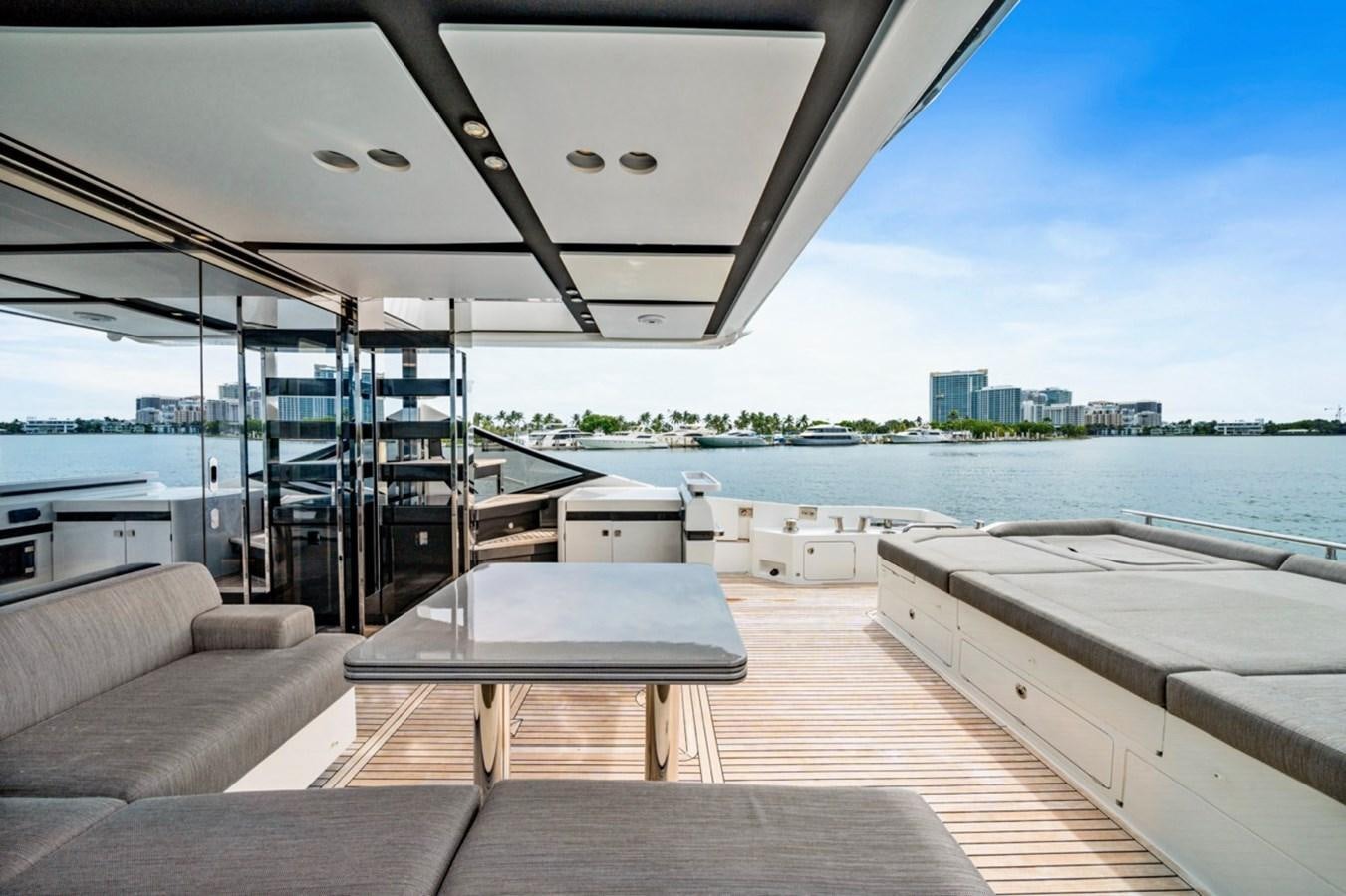 a room with a table and a view of a city aboard JUST KEEP LIVIN Yacht for Sale