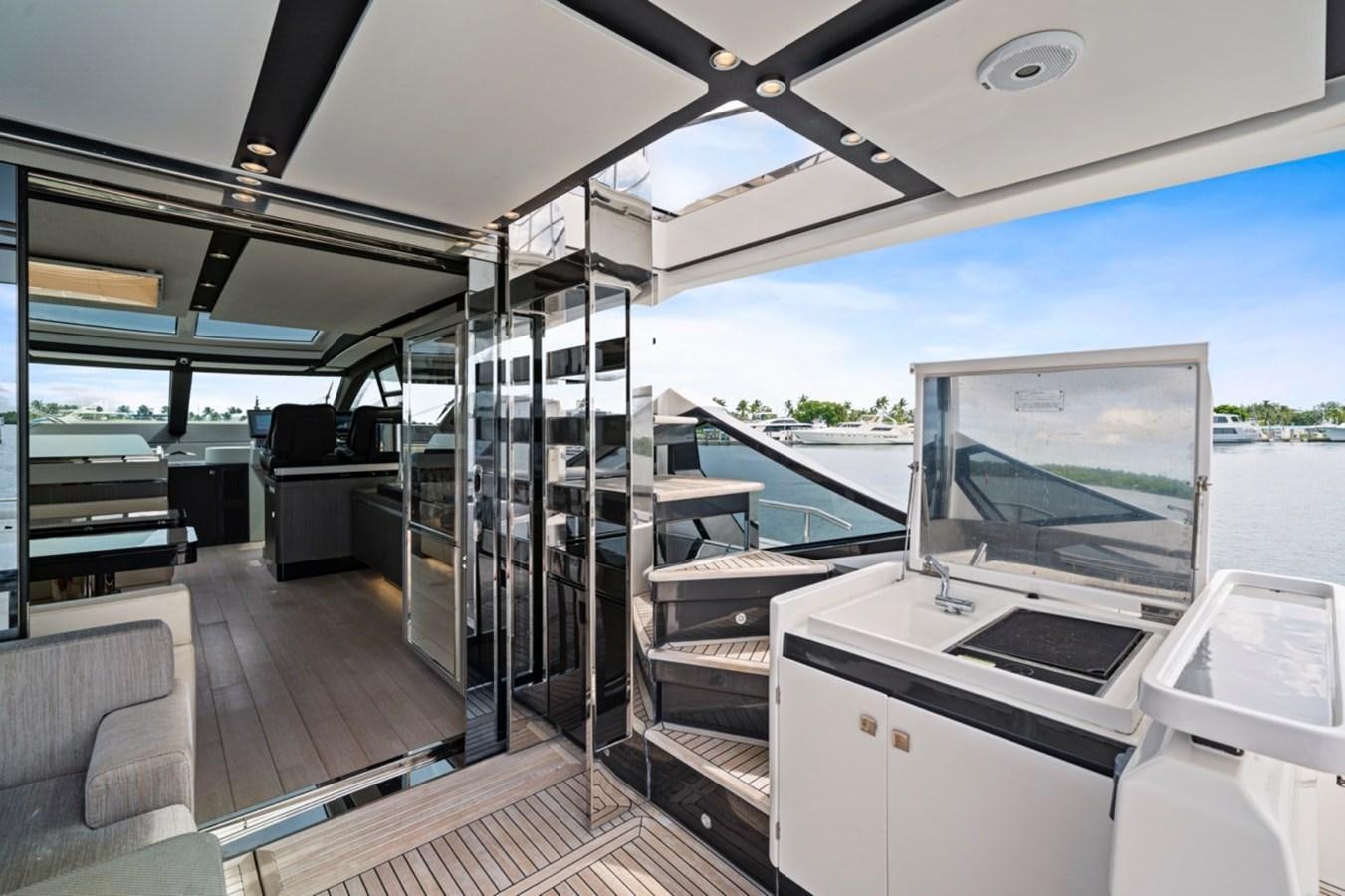 a room with a large glass window and a deck with a pool aboard JUST KEEP LIVIN Yacht for Sale