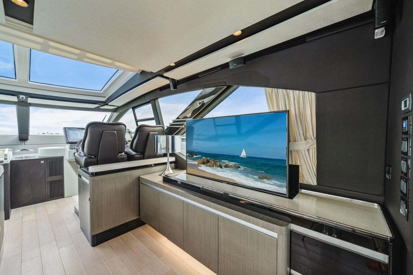 a room with a tv and a couch aboard JUST KEEP LIVIN Yacht for Sale