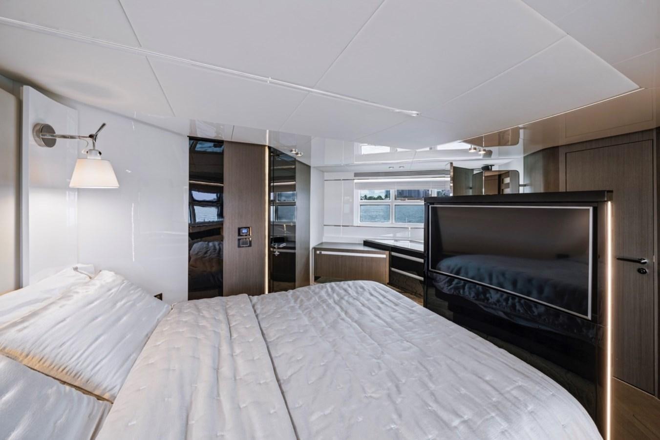 a bed with a television on the wall aboard JUST KEEP LIVIN Yacht for Sale