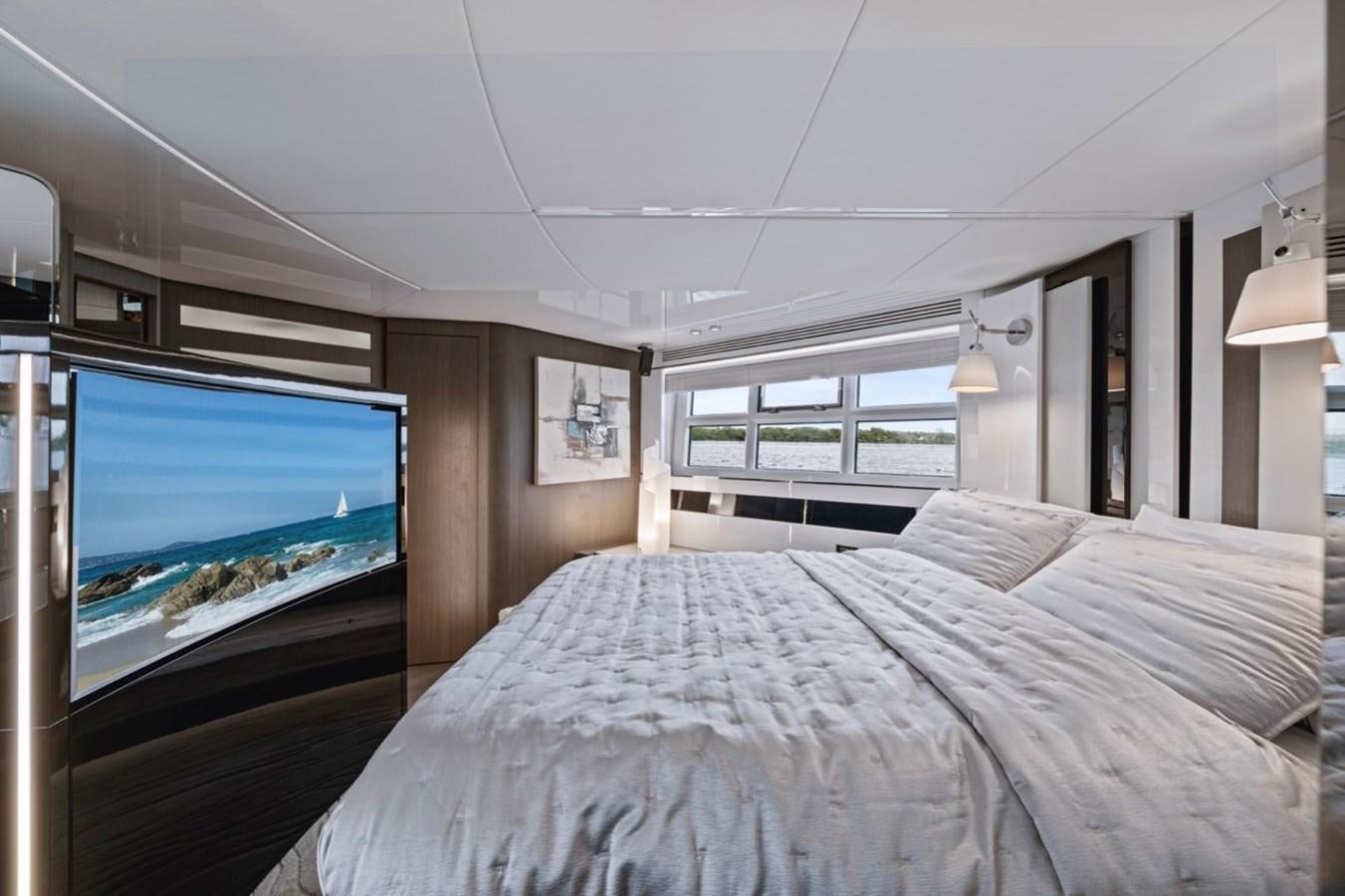 a bed with a television on aboard JUST KEEP LIVIN Yacht for Sale