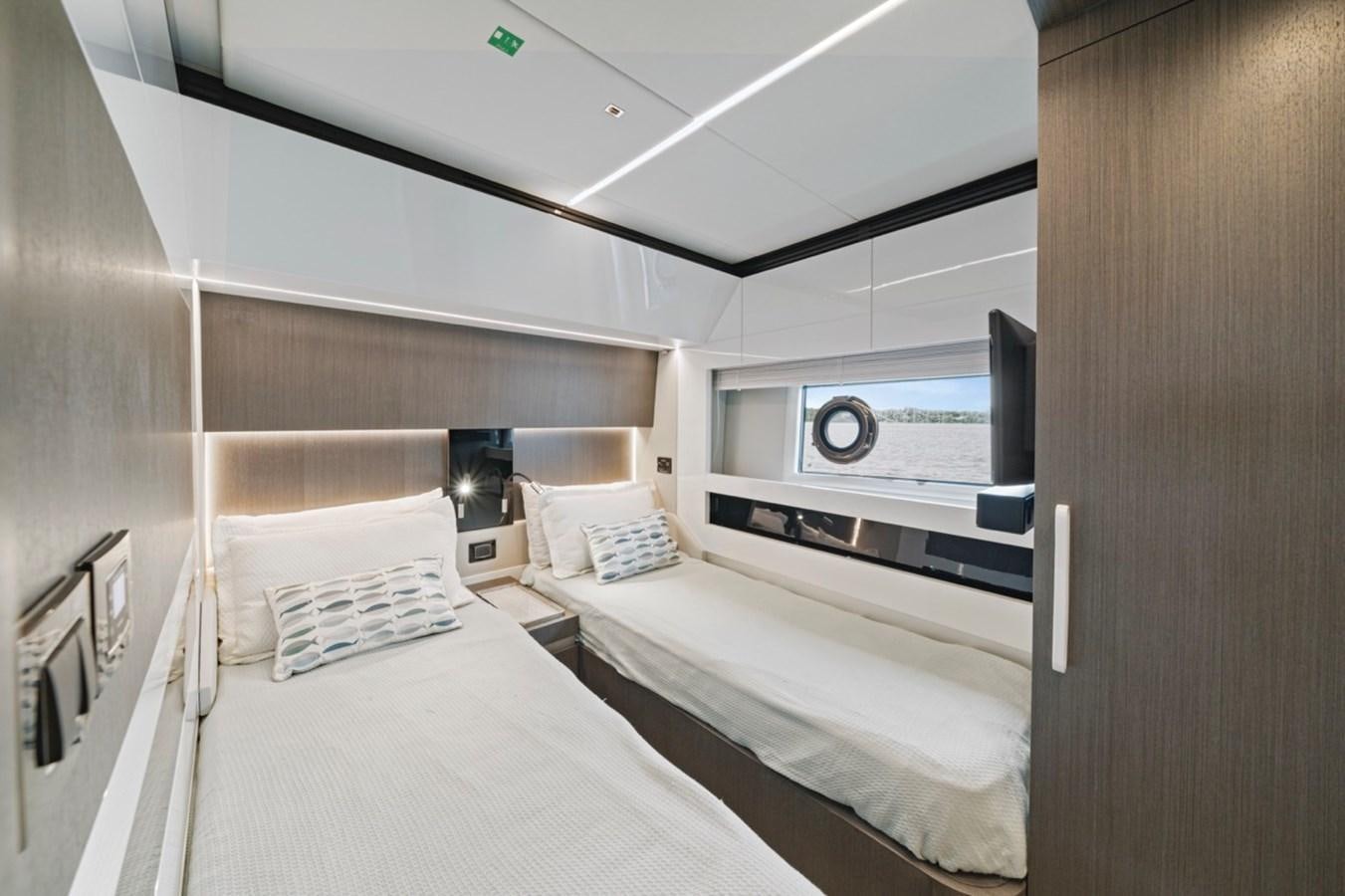 a room with a bed and a television aboard JUST KEEP LIVIN Yacht for Sale