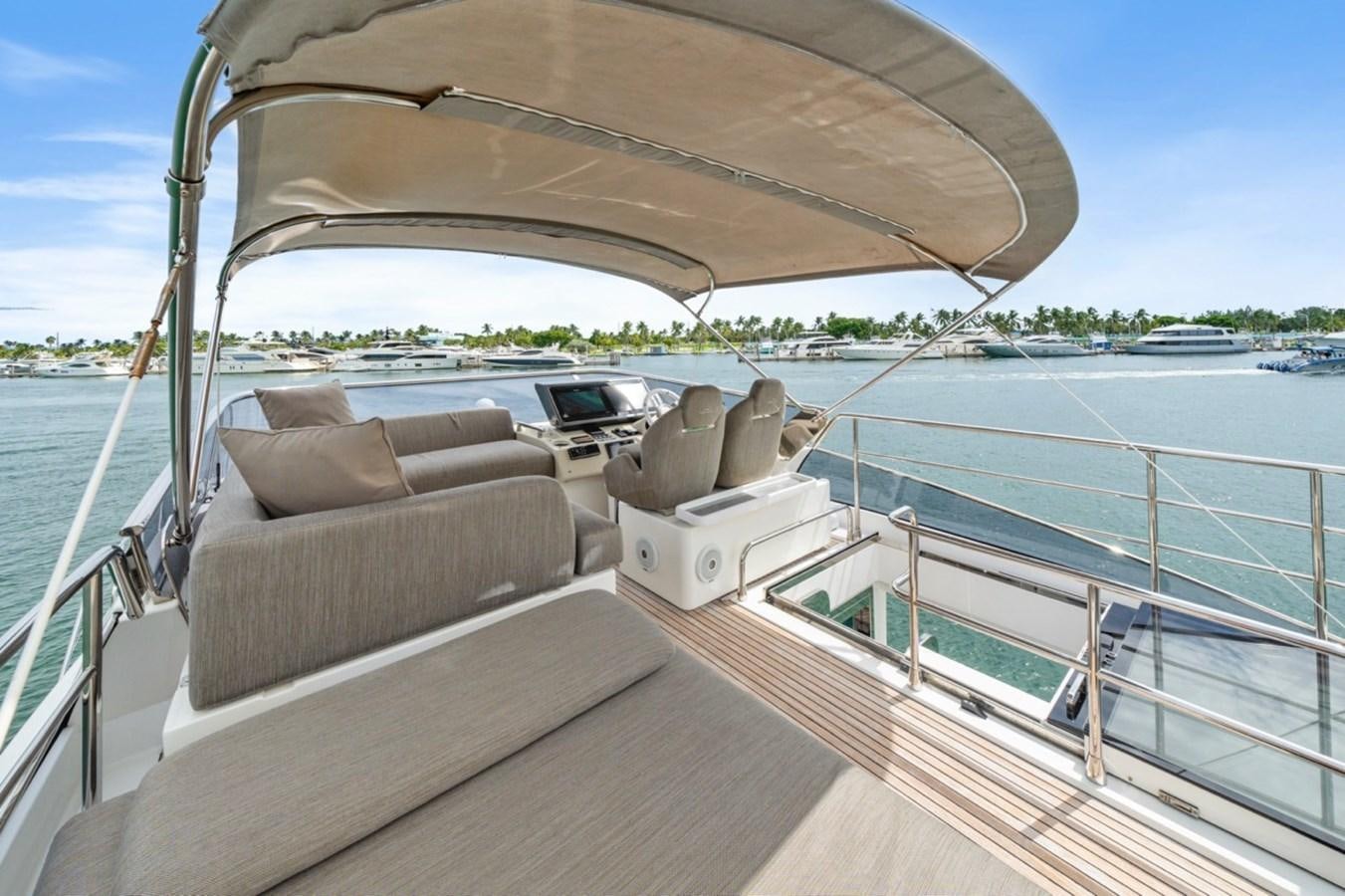 a deck with a chair and a sofa on it aboard JUST KEEP LIVIN Yacht for Sale