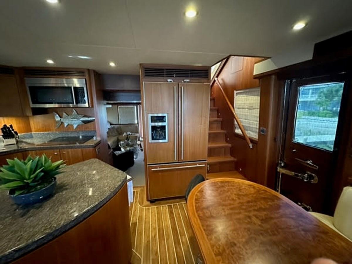 a kitchen with wooden cabinets aboard ISLAND GIRL Yacht for Sale