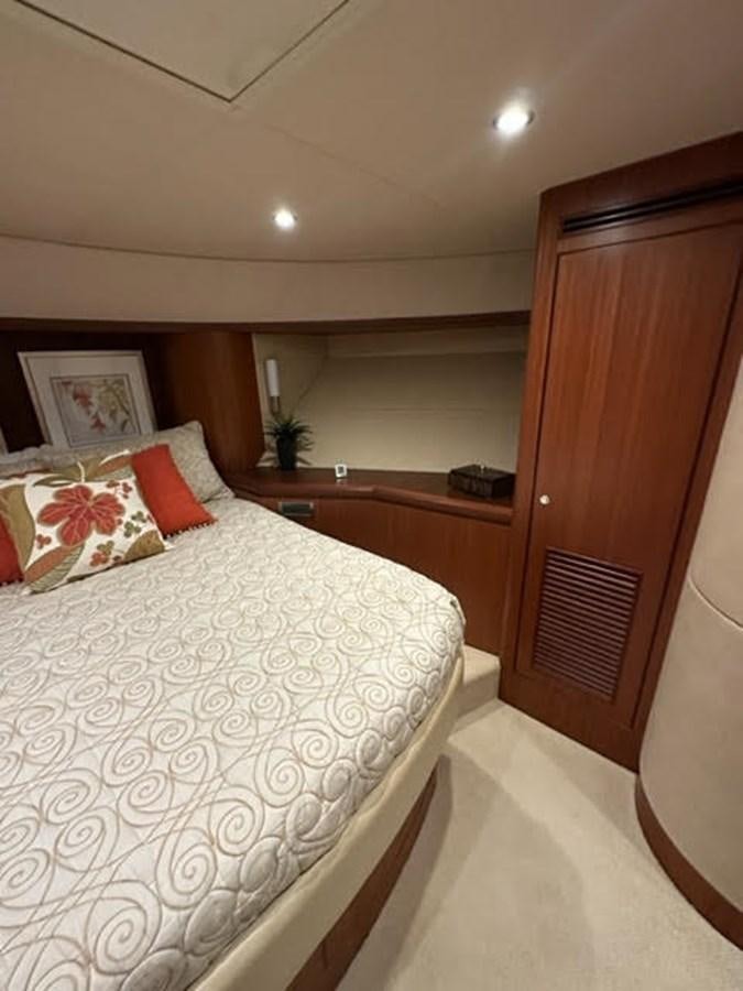 a bedroom with a bed and a closet aboard ISLAND GIRL Yacht for Sale