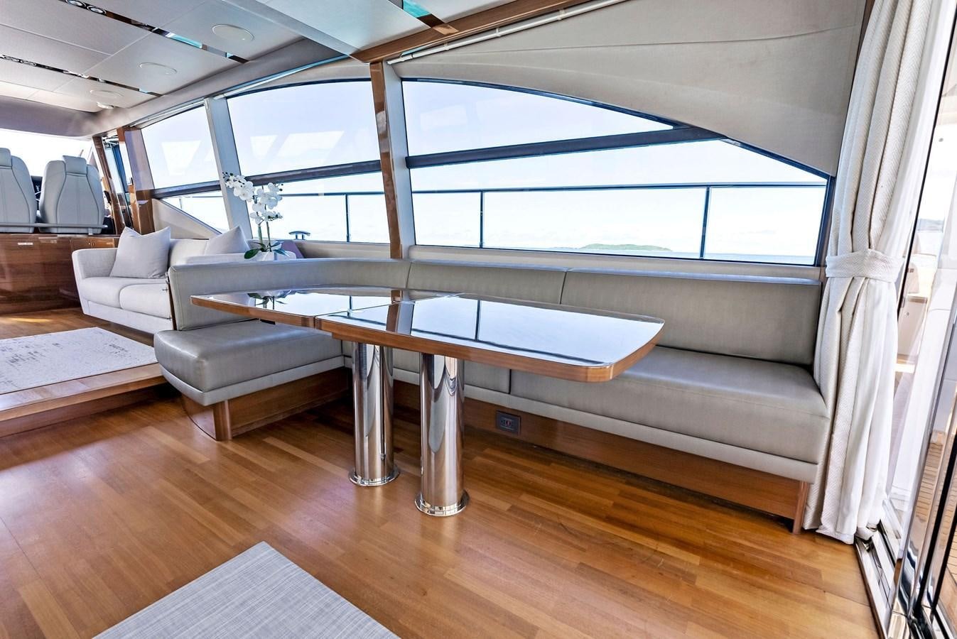 a room with a table and couches aboard SOLIANA Yacht for Sale