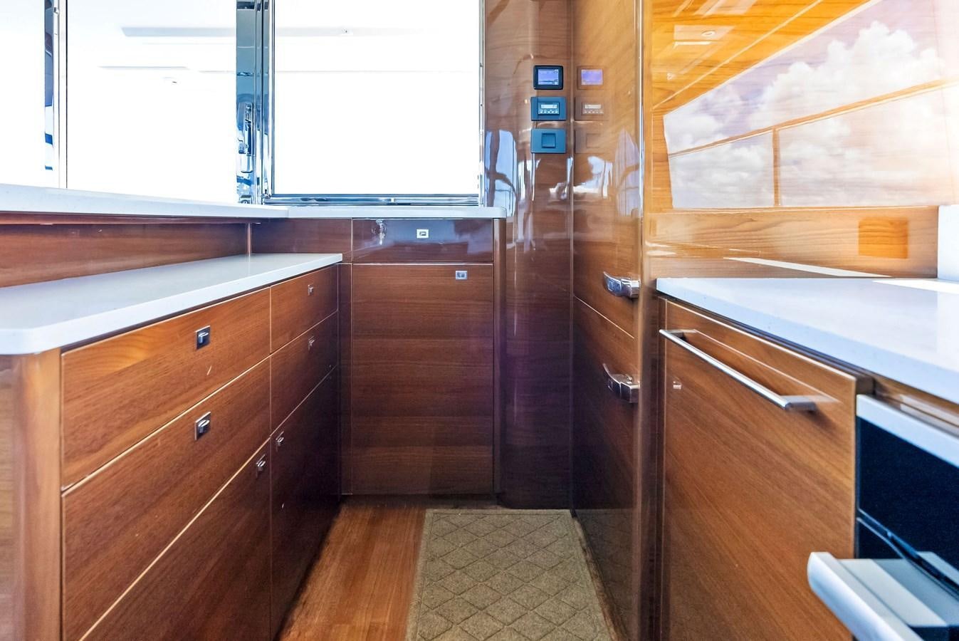 a kitchen with wooden cabinets aboard SOLIANA Yacht for Sale