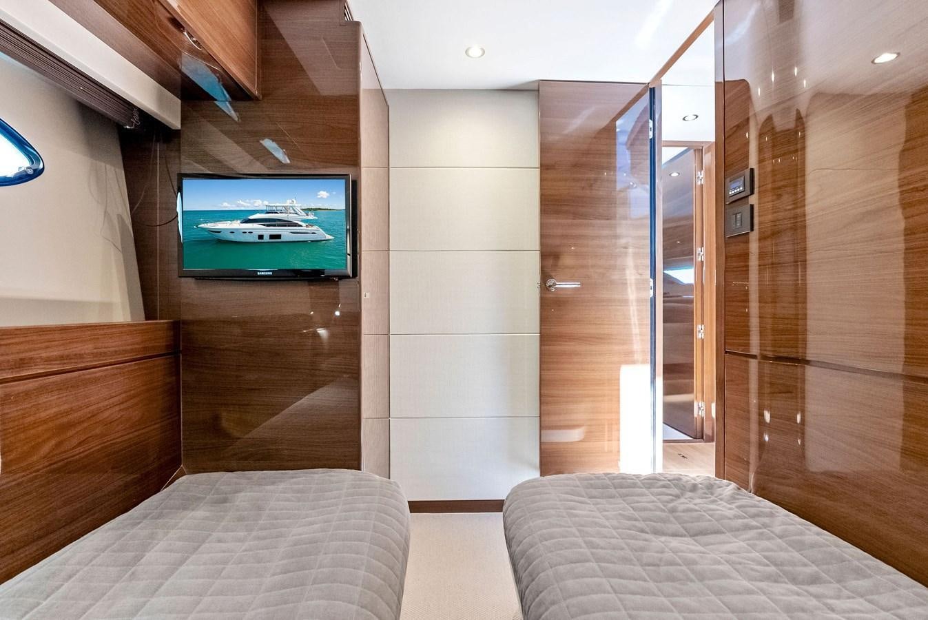 a room with a bed and a tv on the wall aboard SOLIANA Yacht for Sale