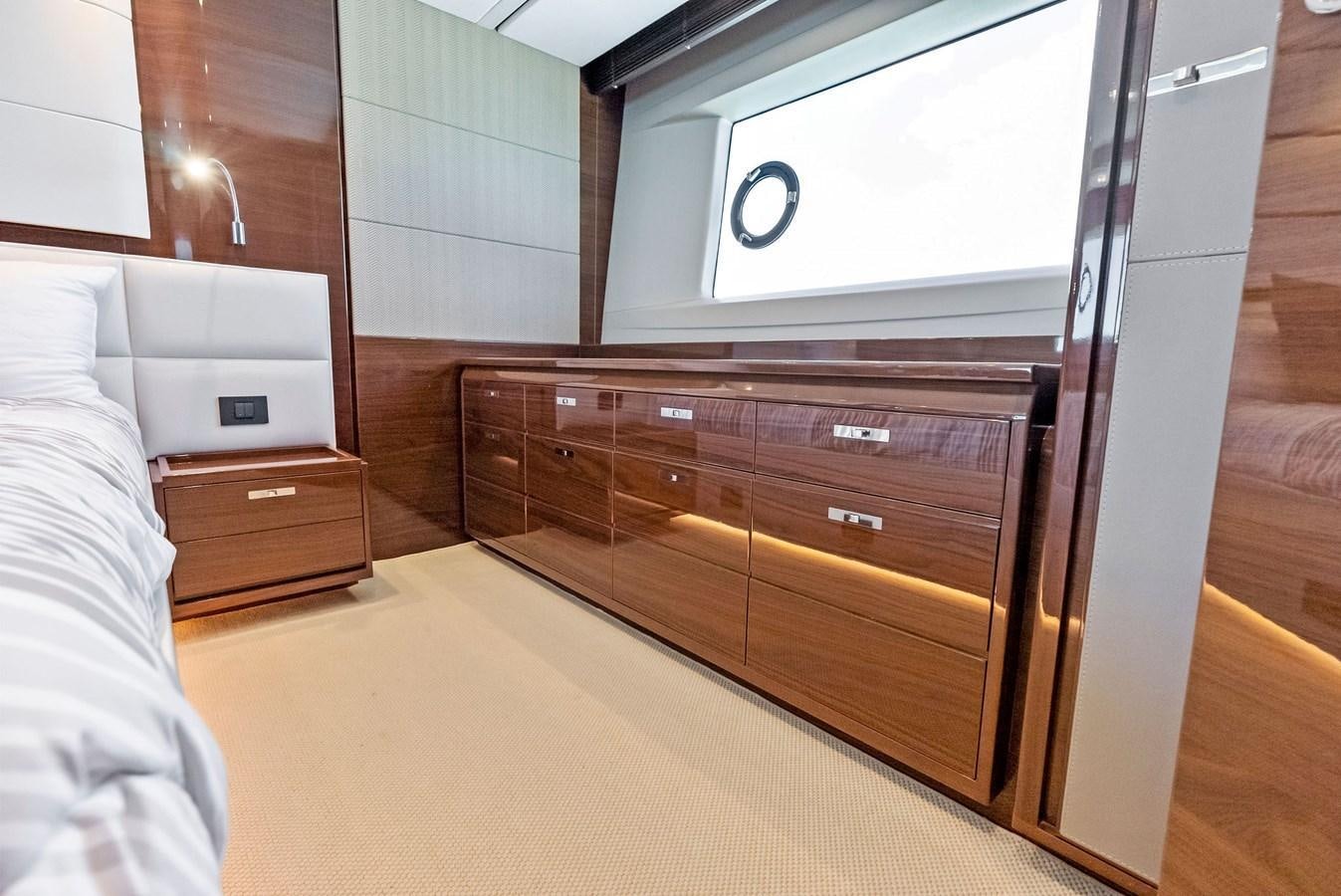 a room with a bed and a dresser aboard SOLIANA Yacht for Sale