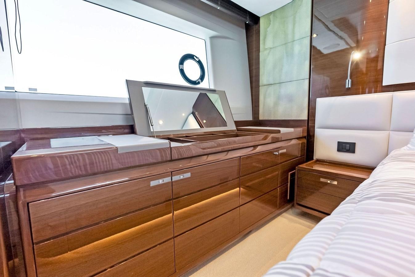 a bedroom with a bed and a laptop on a dresser aboard SOLIANA Yacht for Sale