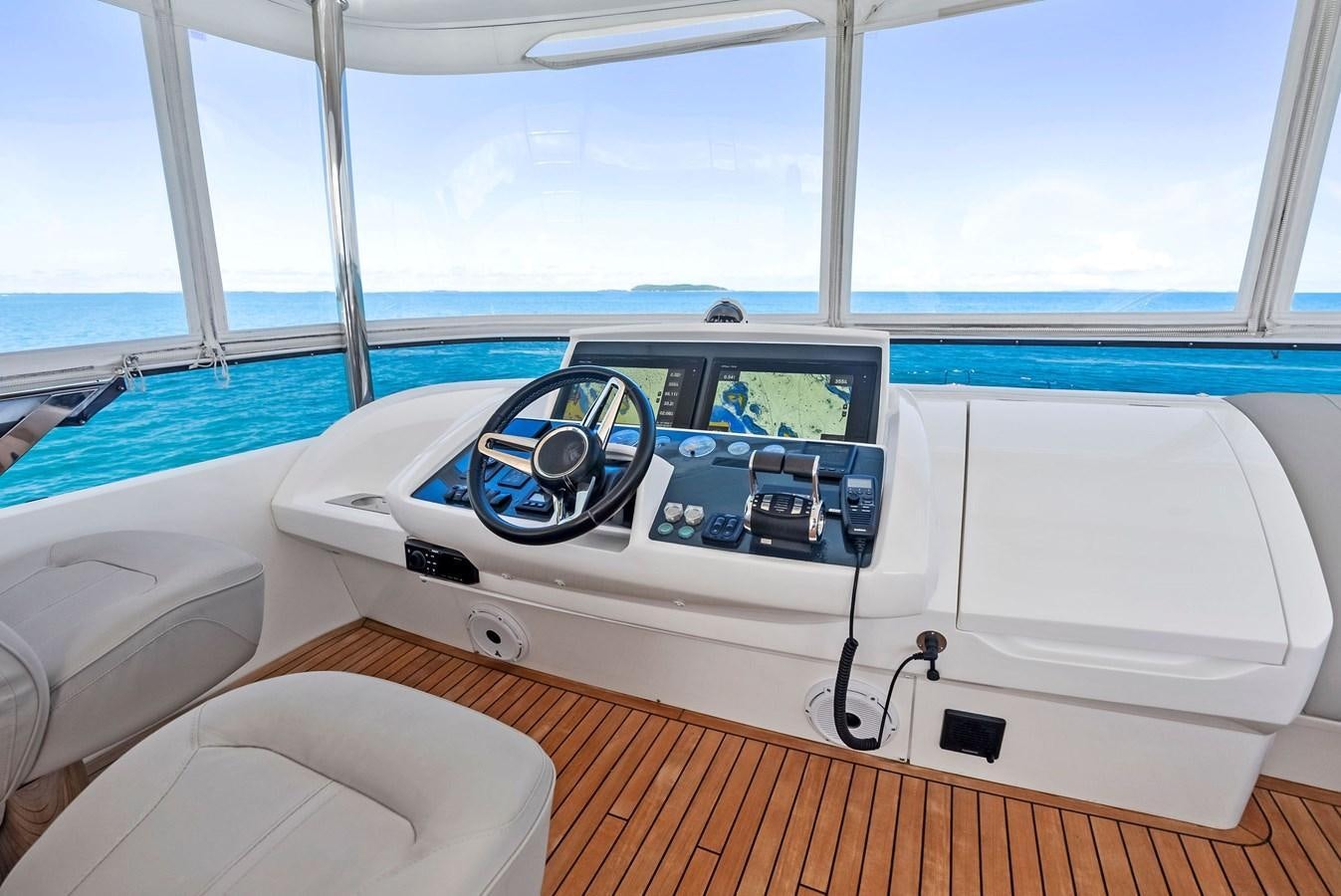 a white boat with a steering wheel aboard SOLIANA Yacht for Sale