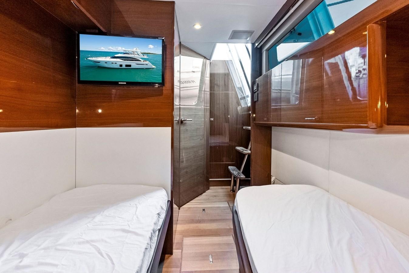 a room with a tv and a bed aboard SOLIANA Yacht for Sale