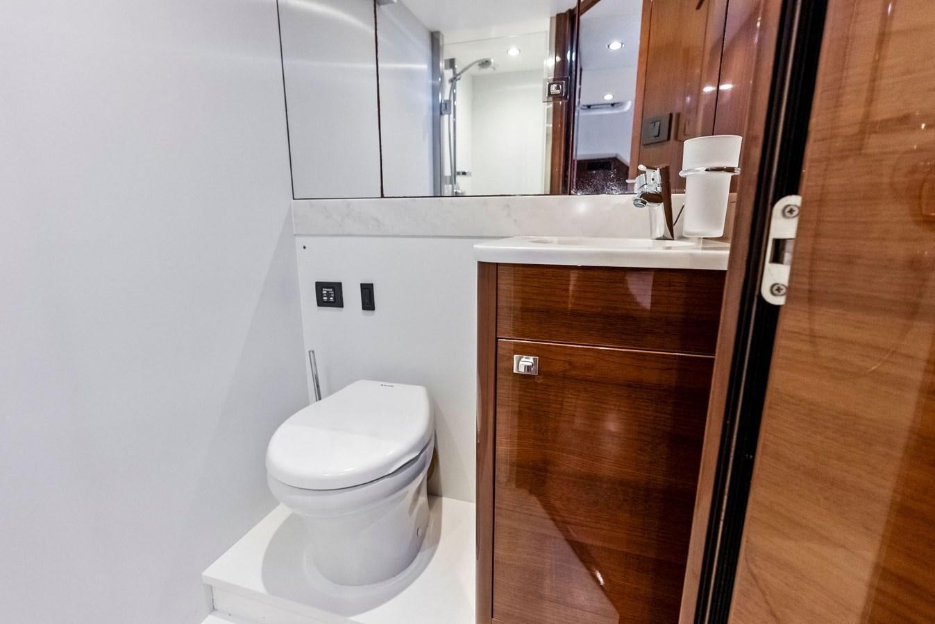 a bathroom with a toilet and a sink aboard SOLIANA Yacht for Sale