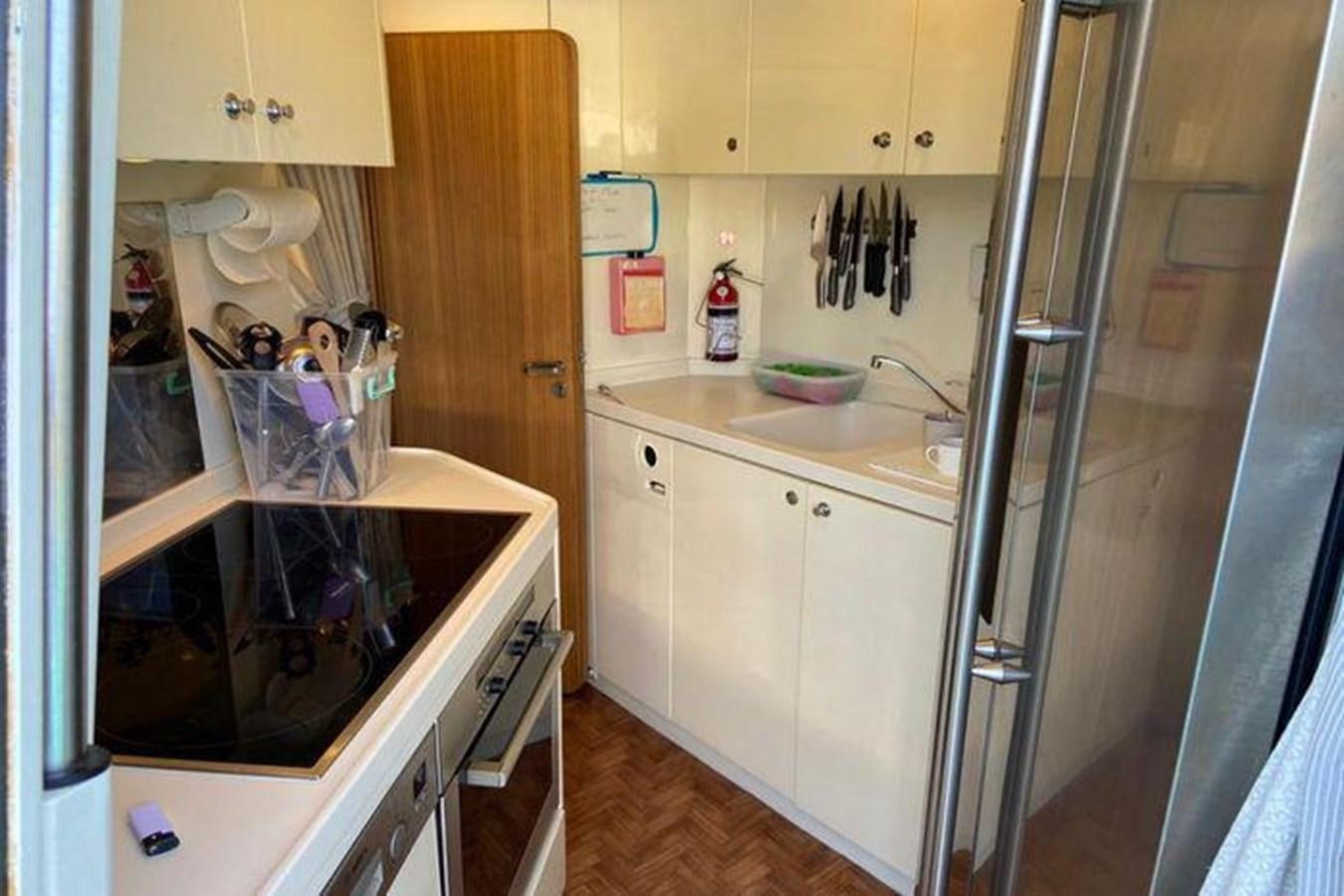 a kitchen with a microwave oven aboard RIVA 85 OPERA SUPER Yacht for Sale