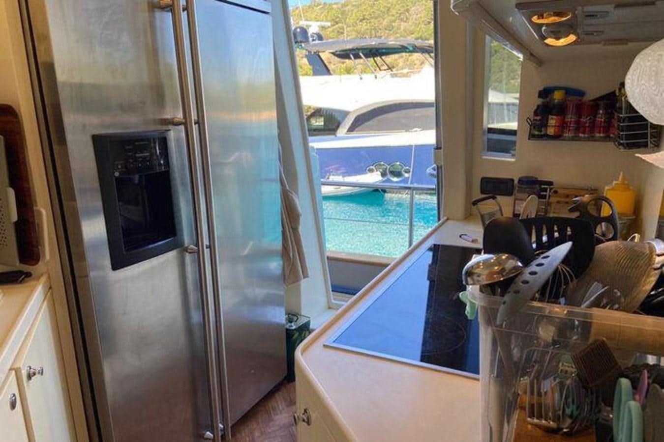a kitchen with a large window aboard RIVA 85 OPERA SUPER Yacht for Sale