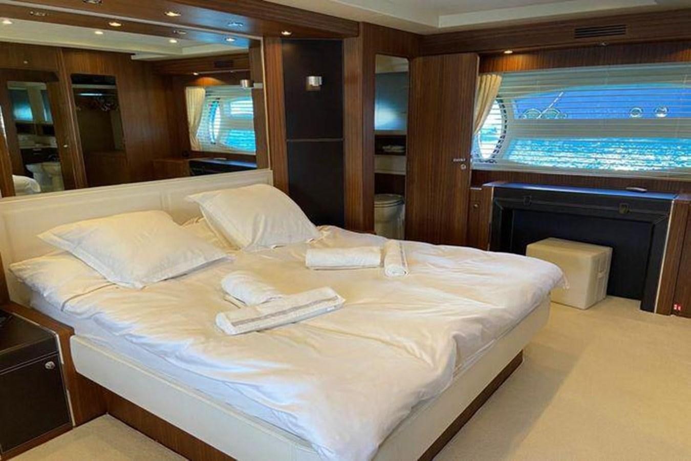 a bed with white sheets aboard RIVA 85 OPERA SUPER Yacht for Sale