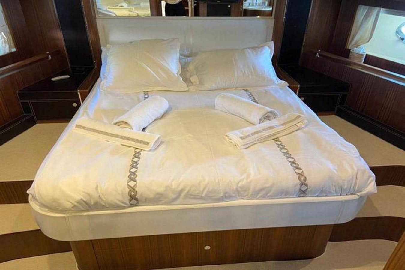 a bed with white sheets aboard RIVA 85 OPERA SUPER Yacht for Sale