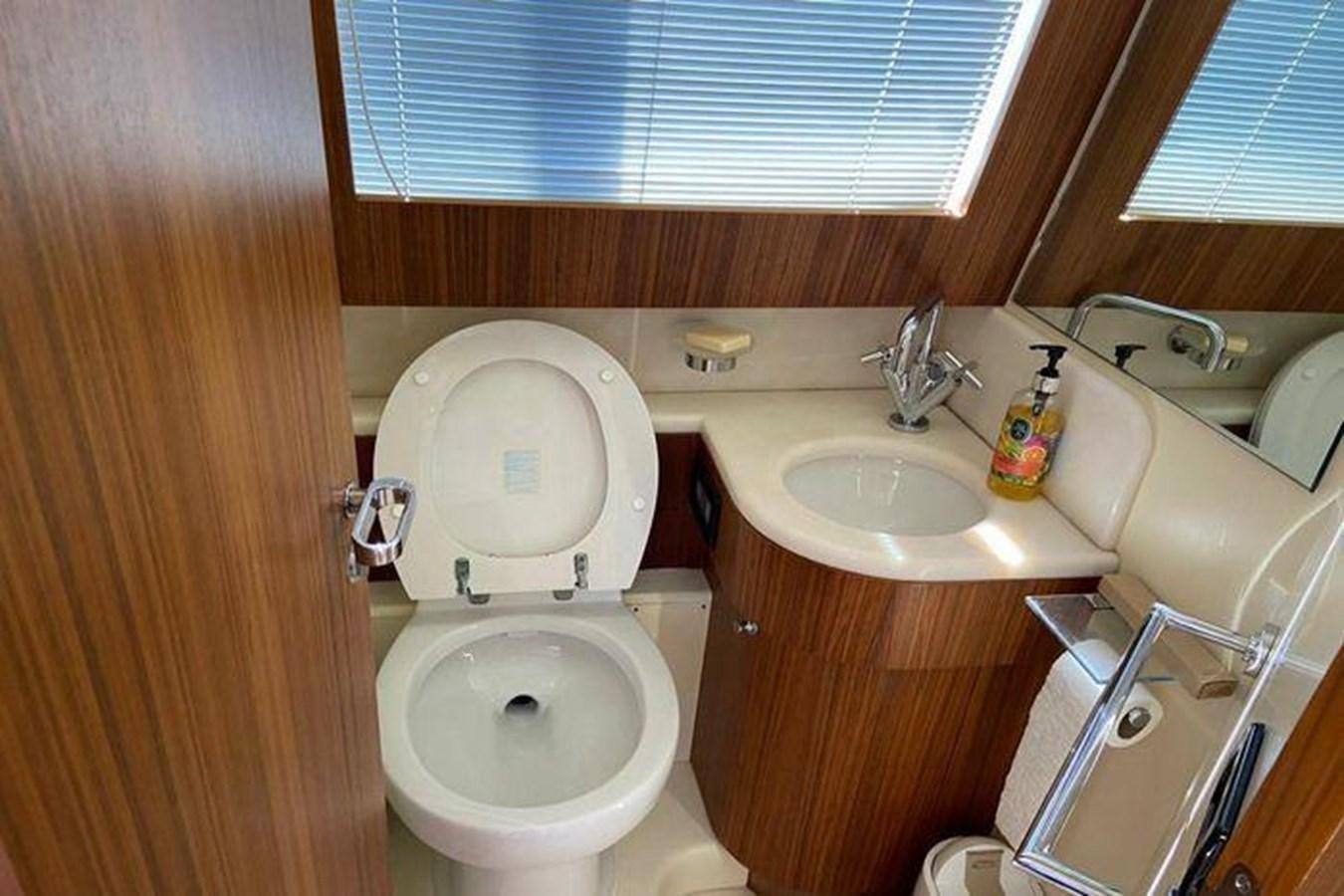 a bathroom with a toilet sink and a window aboard RIVA 85 OPERA SUPER Yacht for Sale