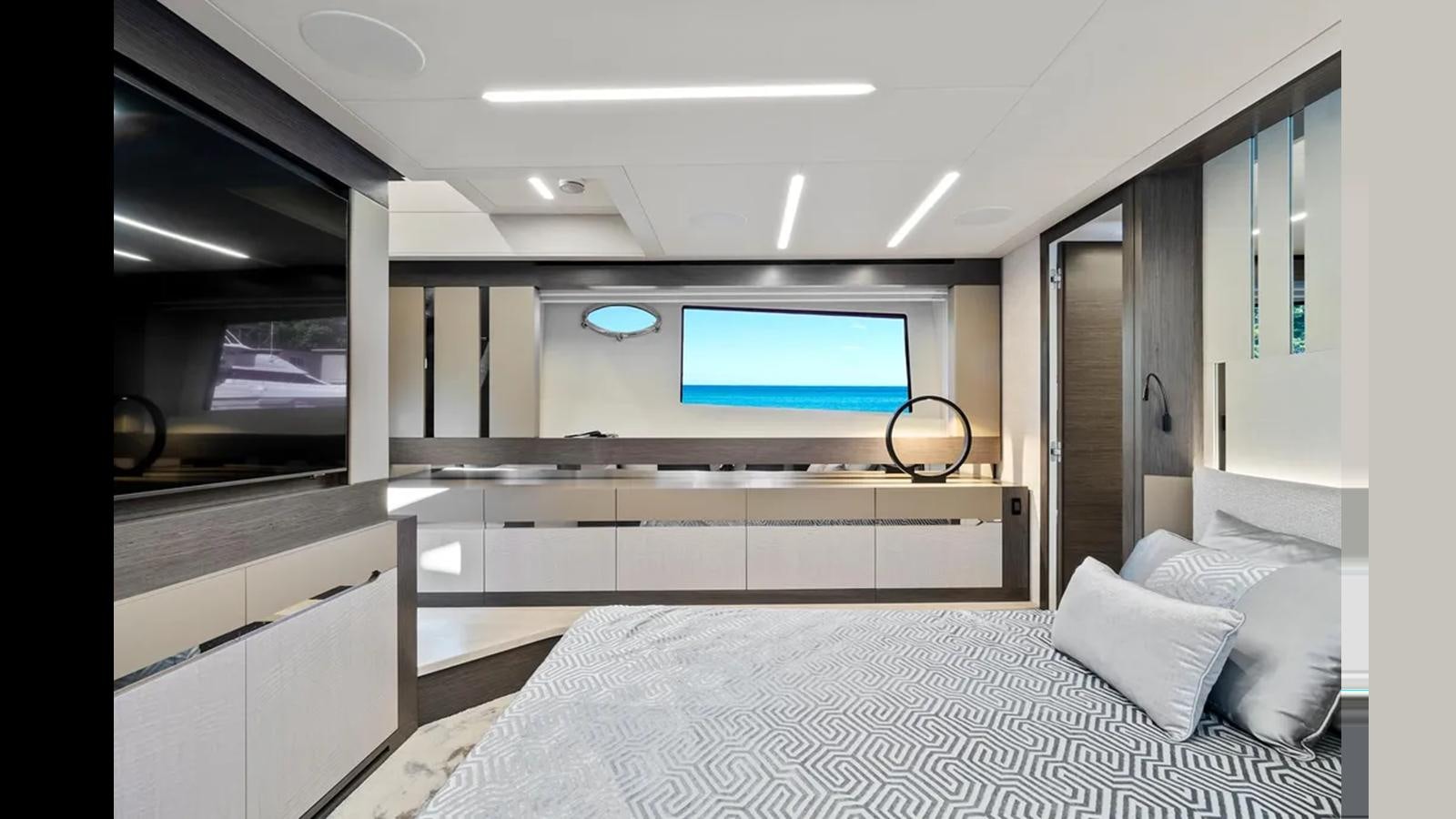 a room with a bed and a large television aboard 2023 80' PERSHING 8X Yacht for Sale