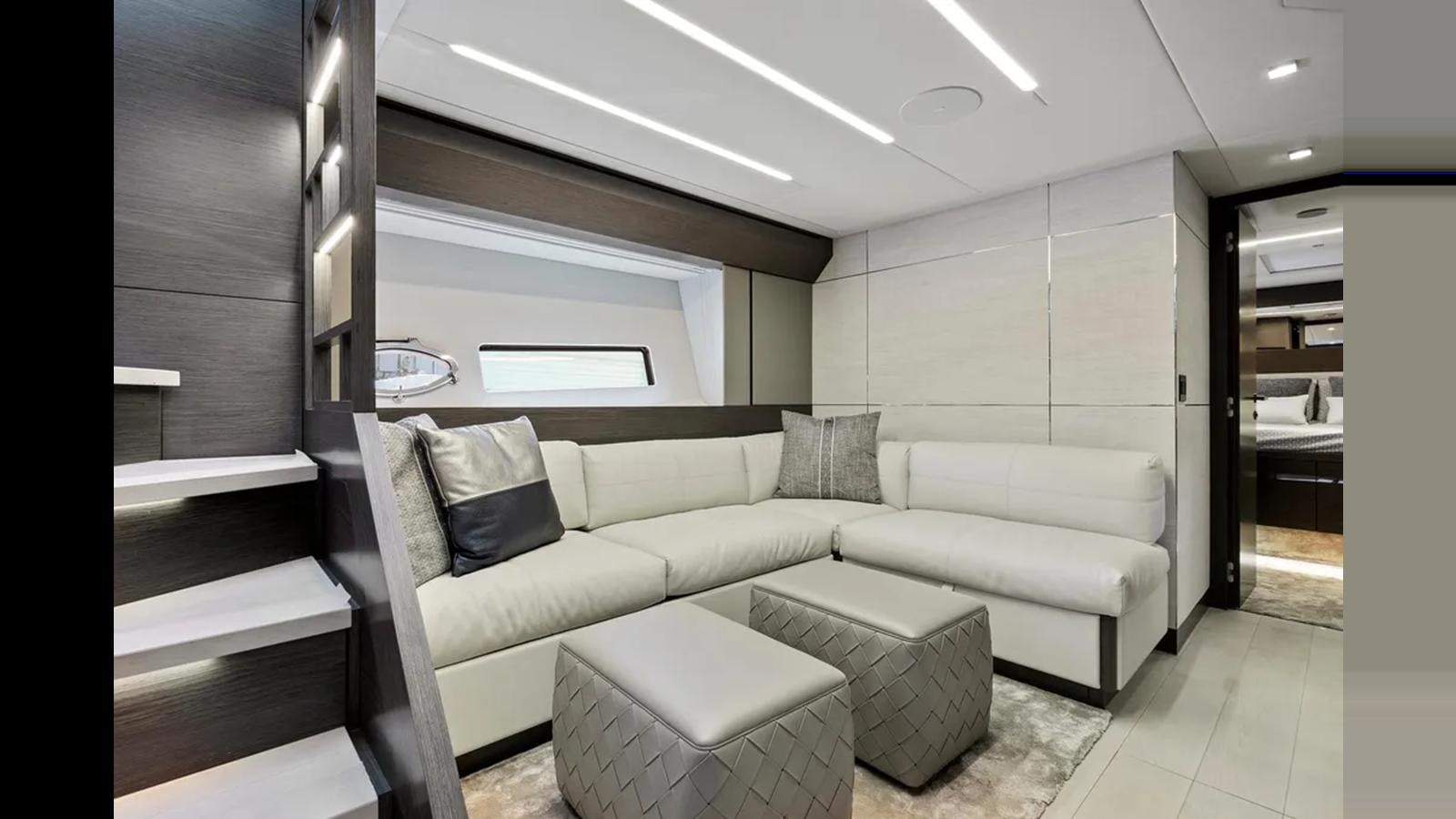 a room with a couch and a table aboard 2023 80' PERSHING 8X Yacht for Sale