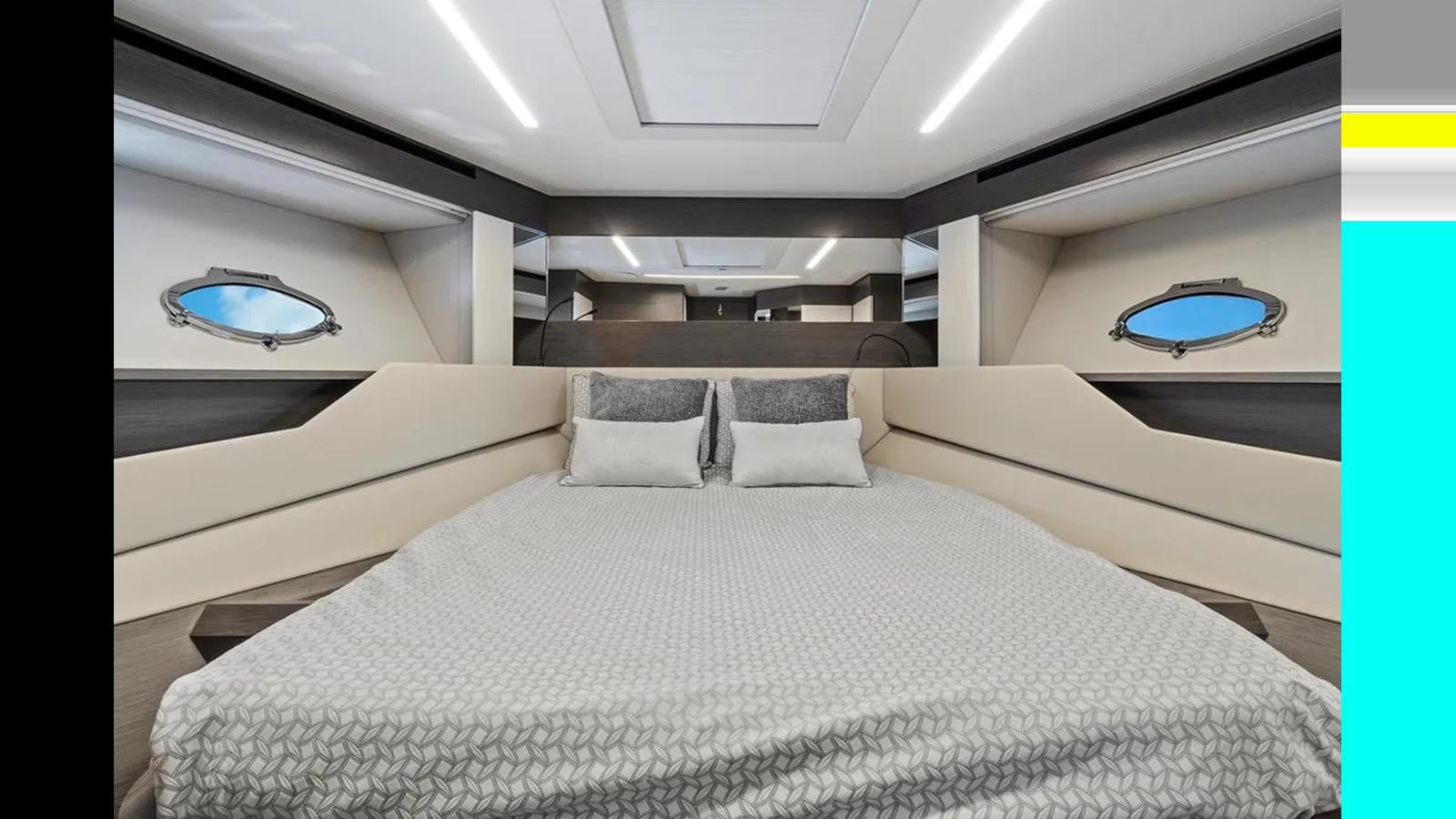 a room with a bed and a window aboard 2023 80' PERSHING 8X Yacht for Sale
