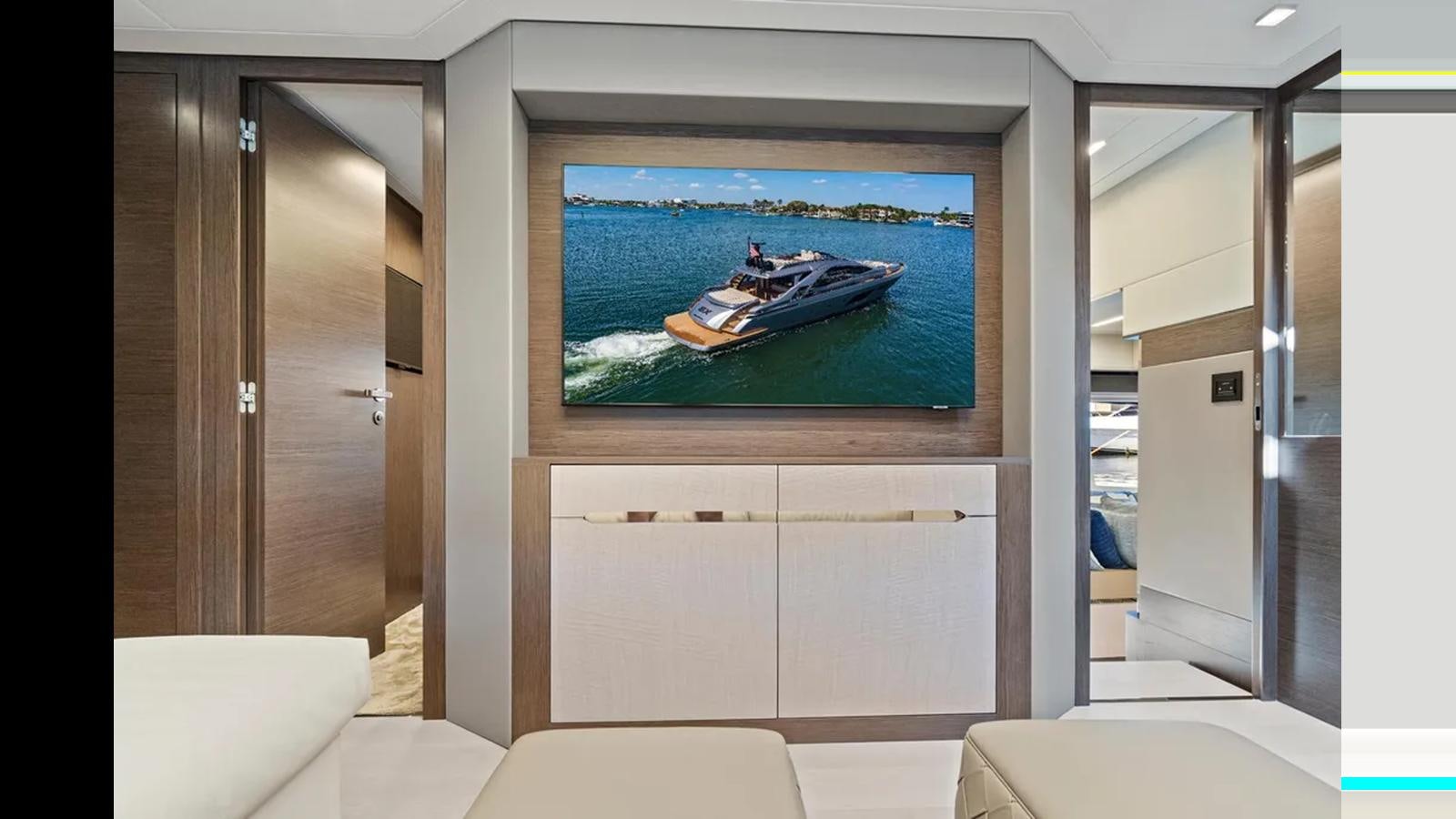 a room with a large television aboard 2023 80' PERSHING 8X Yacht for Sale