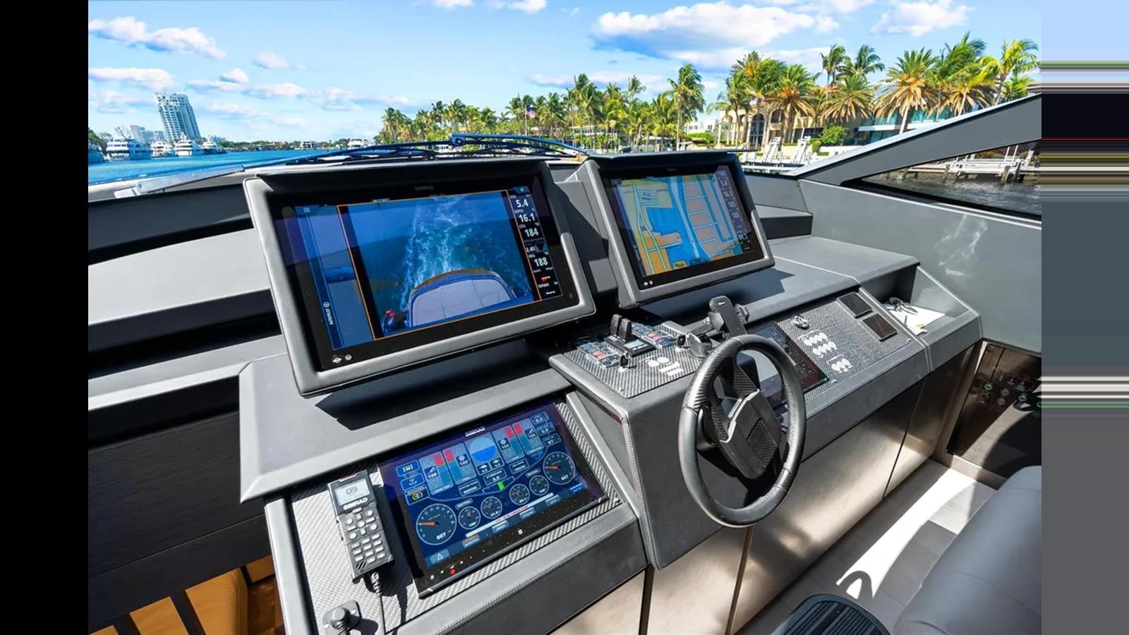 a group of monitors and a game console in a car aboard 2023 80' PERSHING 8X Yacht for Sale