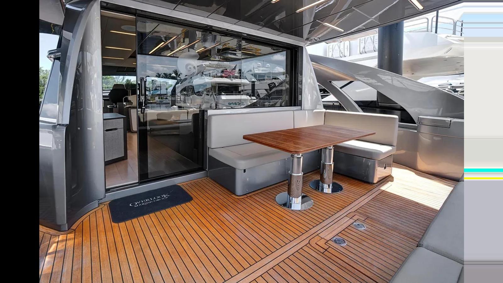 a room with a table and chairs aboard 2023 80' PERSHING 8X Yacht for Sale