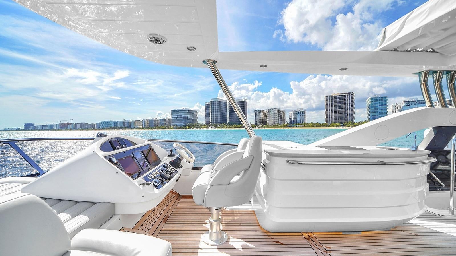 a couple of white boats on a dock with a city in the background aboard M4 Yacht for Sale
