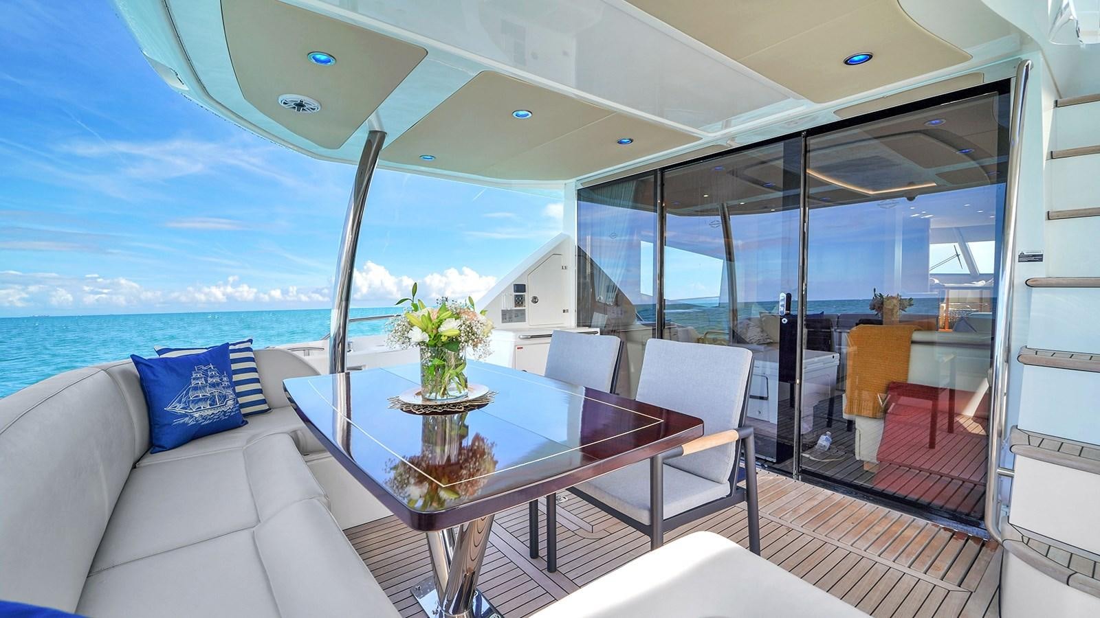 a room with a table and chairs aboard M4 Yacht for Sale