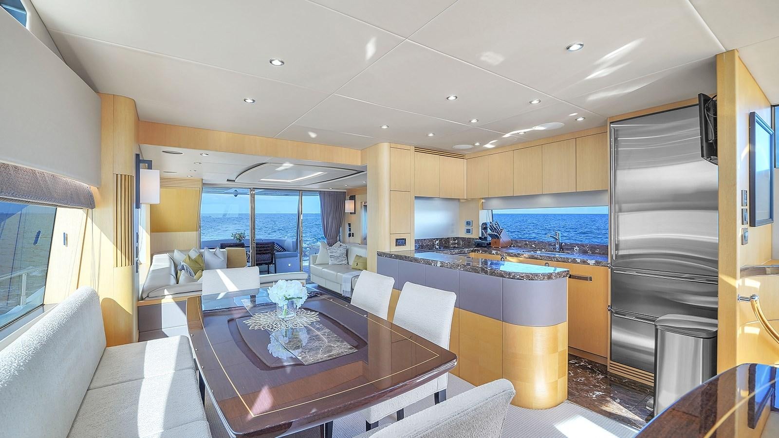 a large kitchen with a table and chairs aboard M4 Yacht for Sale
