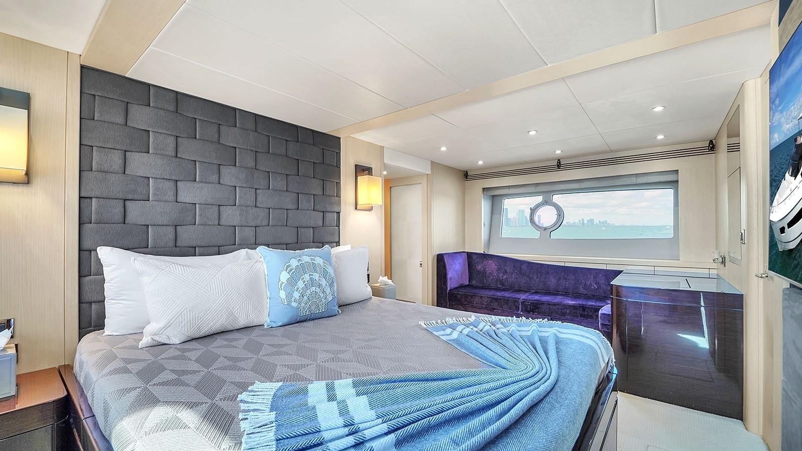 a room with a bed and a couch aboard M4 Yacht for Sale