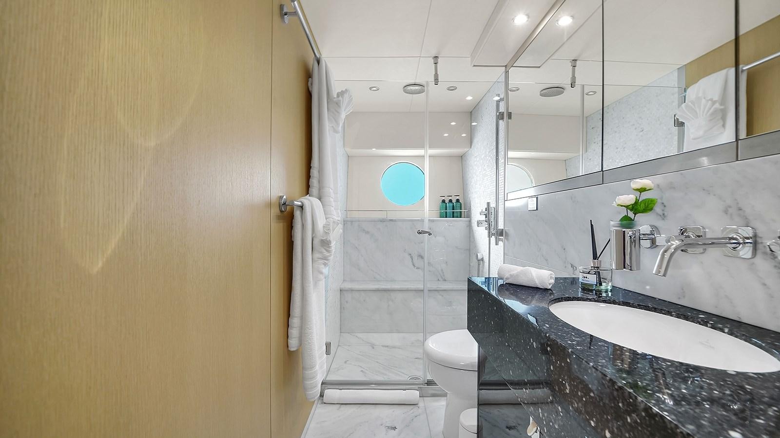 a bathroom with a marble countertop aboard M4 Yacht for Sale