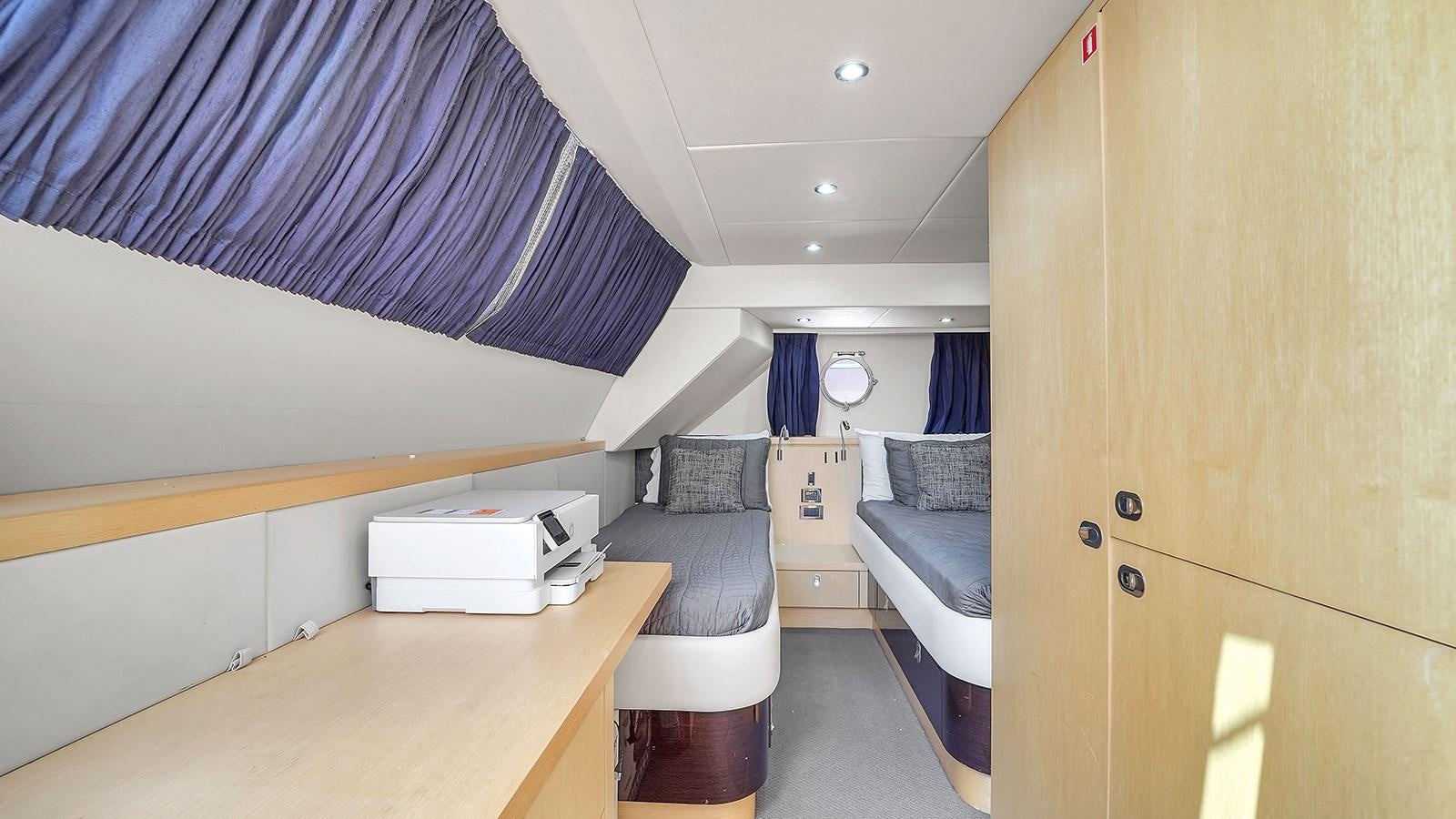 a room with a bed and a desk aboard M4 Yacht for Sale