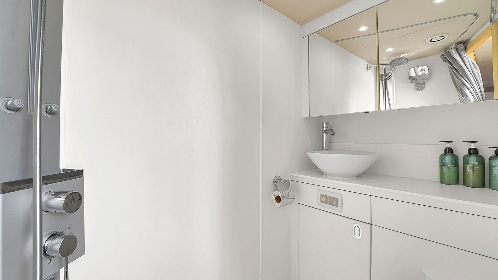 a bathroom with a sink and mirror aboard M4 Yacht for Sale
