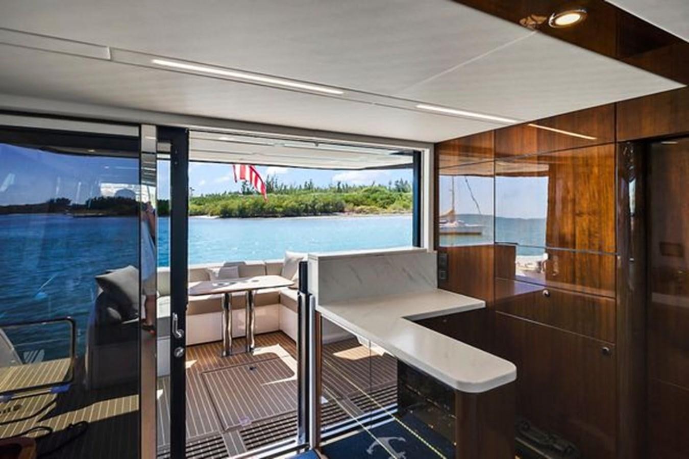 a room with a table and chairs aboard 2021 FAIRLINE SQUADRON 68 Yacht for Sale