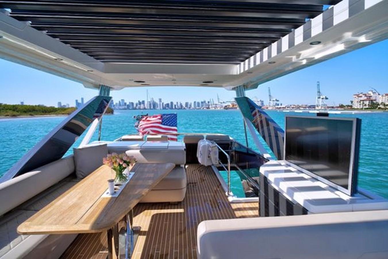 a deck with a view of a city and water aboard 2021 FAIRLINE SQUADRON 68 Yacht for Sale