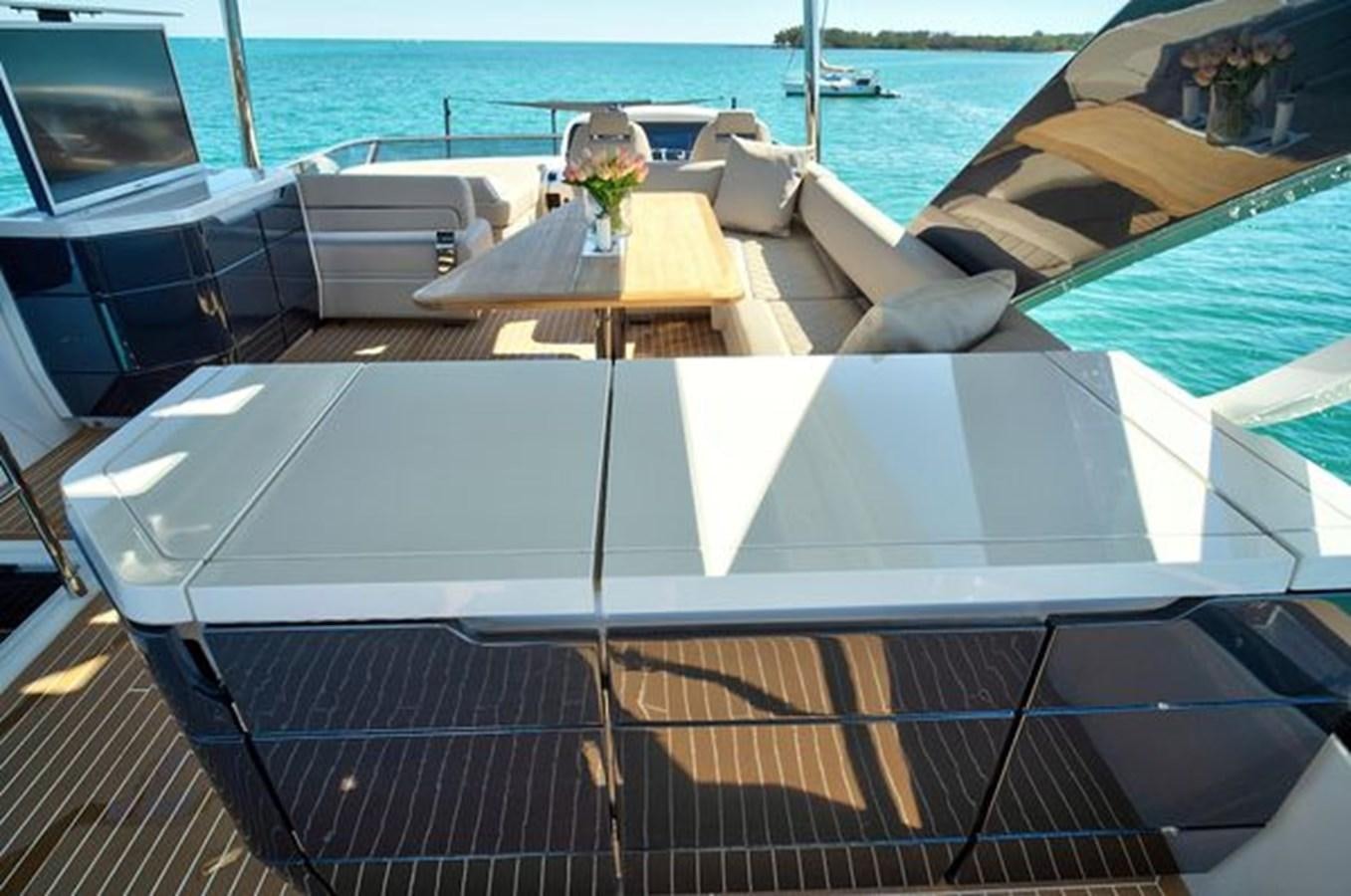 a deck with a view of the ocean and boats aboard 2021 FAIRLINE SQUADRON 68 Yacht for Sale