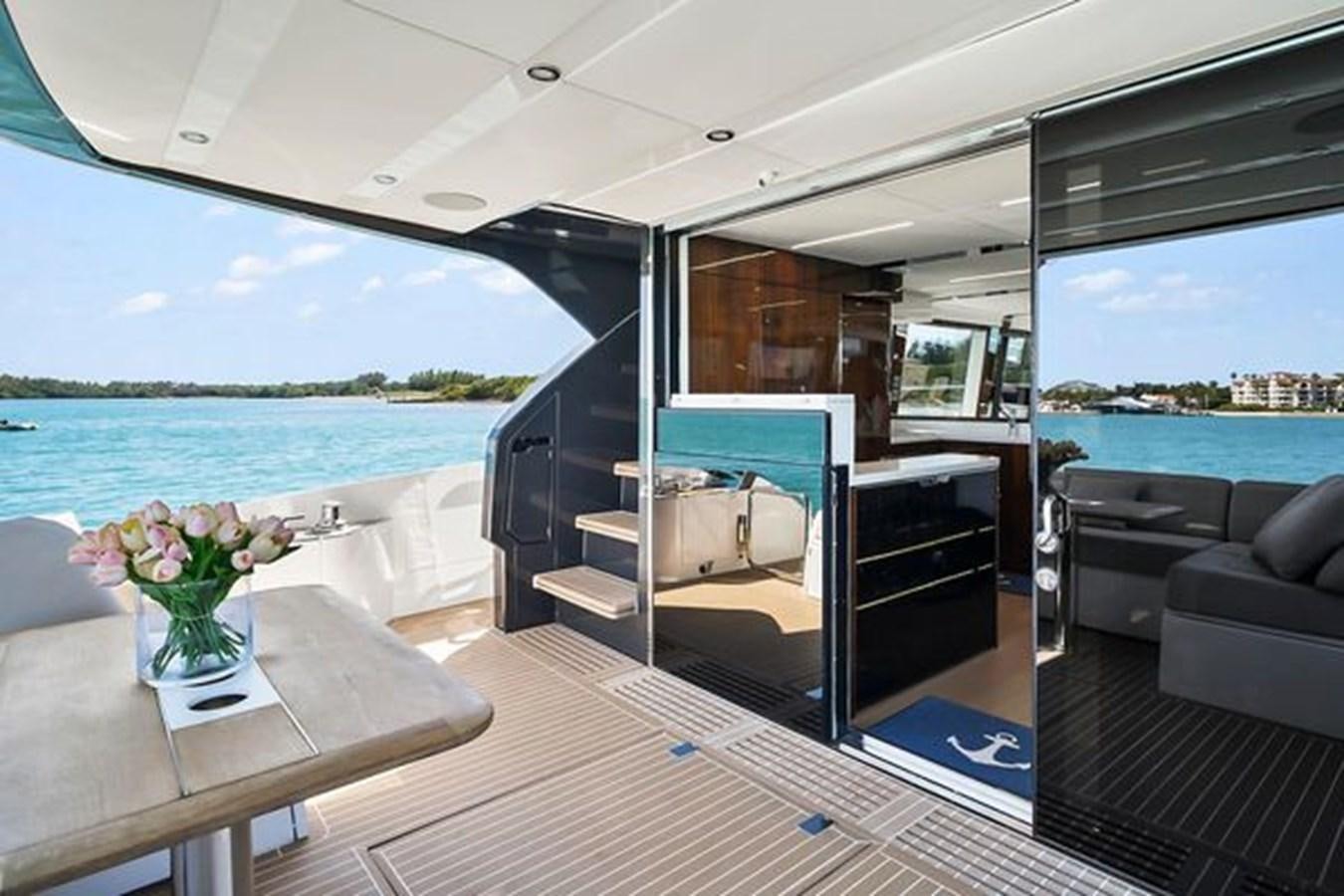a boat with a table and chairs aboard 2021 FAIRLINE SQUADRON 68 Yacht for Sale