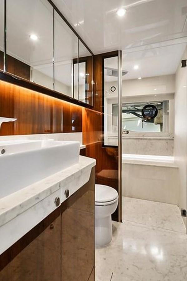 a bathroom with a sink and toilet aboard 2021 FAIRLINE SQUADRON 68 Yacht for Sale