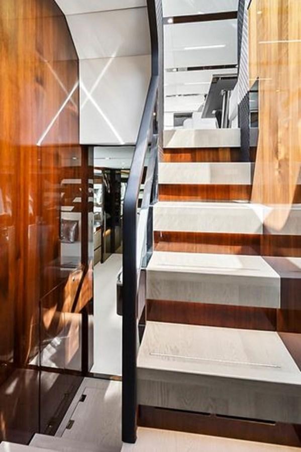 a set of wooden stairs aboard 2021 FAIRLINE SQUADRON 68 Yacht for Sale