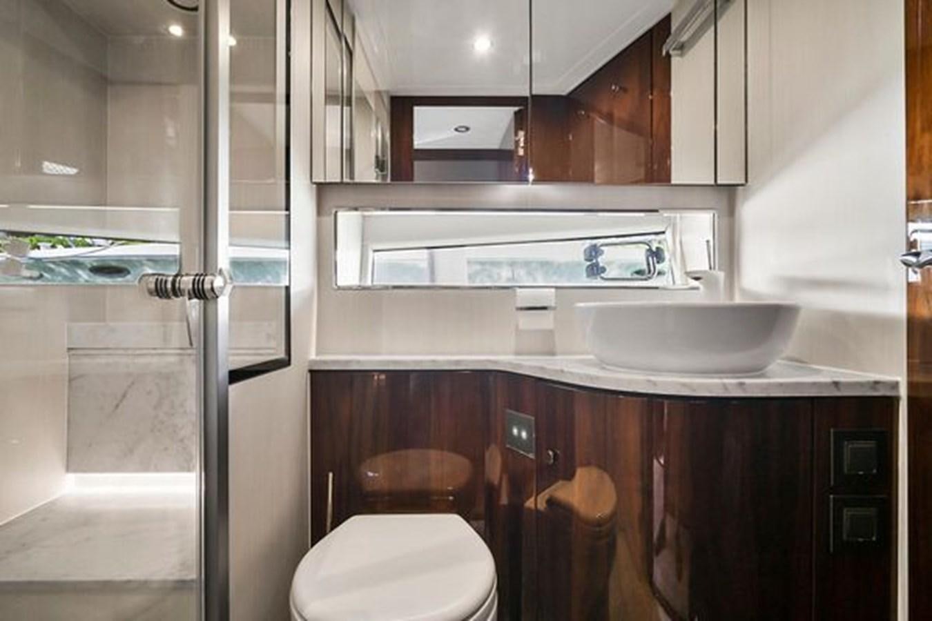 a kitchen with a sink and a toilet aboard 2021 FAIRLINE SQUADRON 68 Yacht for Sale
