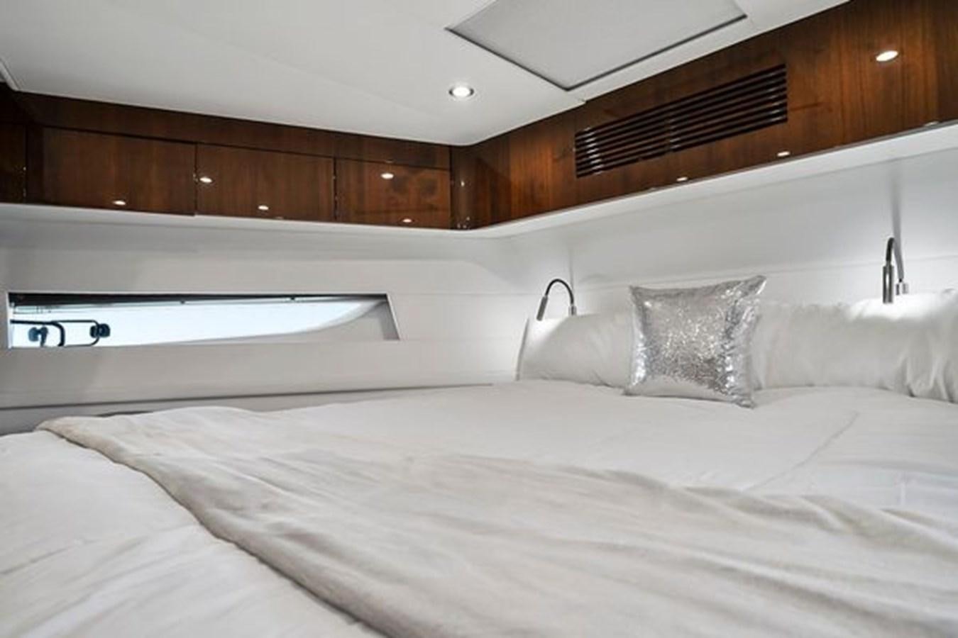a bed with white sheets aboard 2021 FAIRLINE SQUADRON 68 Yacht for Sale