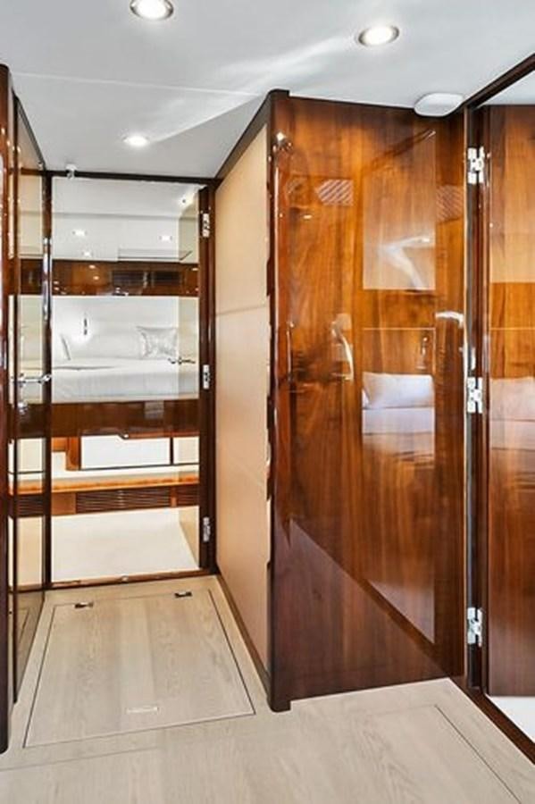 a room with wooden doors aboard 2021 FAIRLINE SQUADRON 68 Yacht for Sale