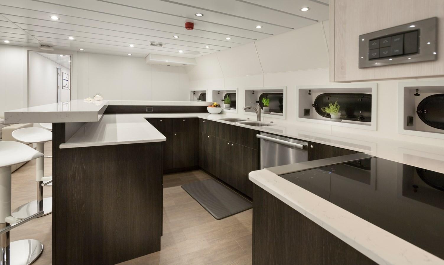 a kitchen with white cabinets aboard AXIS Yacht for Sale