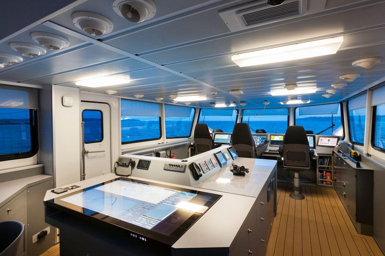 a room with computers and chairs aboard AXIS Yacht for Sale