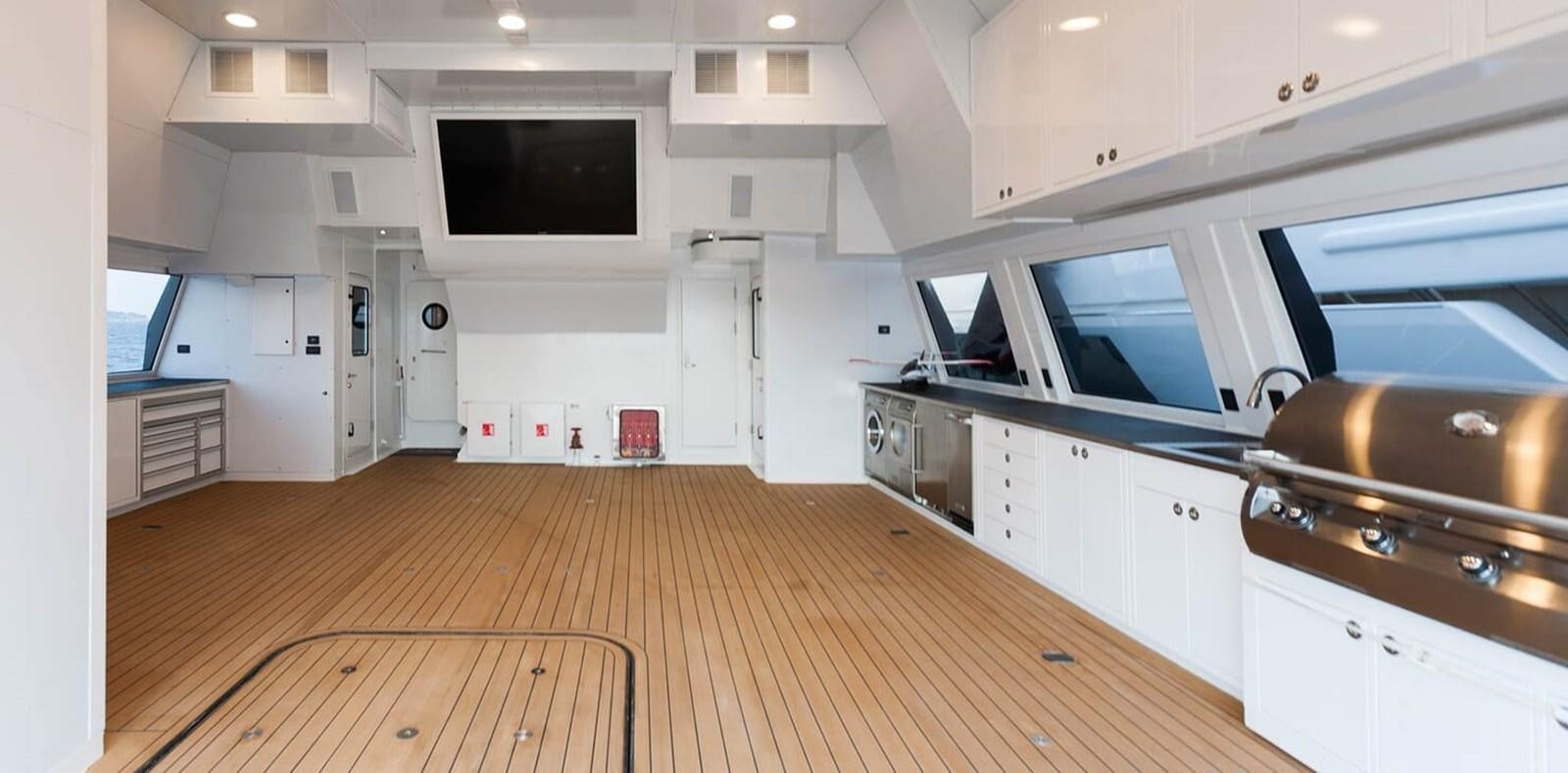 a large kitchen with white cabinets aboard AXIS Yacht for Sale